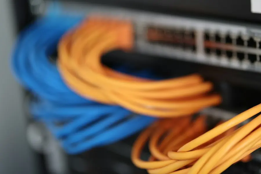 Network switch with blue and orange patch cables in a server rack